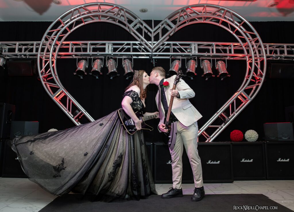 Bride and Groom Standing Kissing at Rock N Roll Wedding