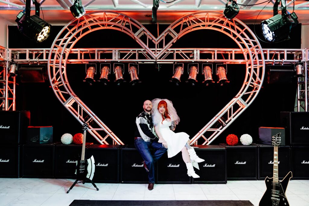 Wedding bride and groom sitting at Rock N Roll Wedding Chapel